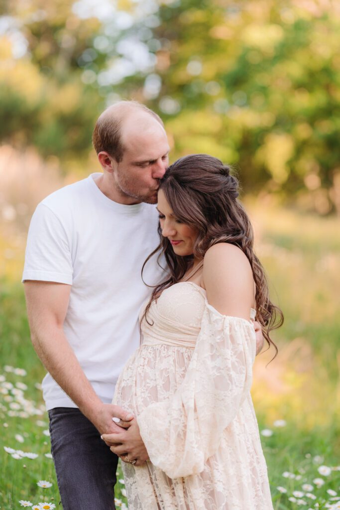 outdoor maternity session Asheville NC in a field of daisies